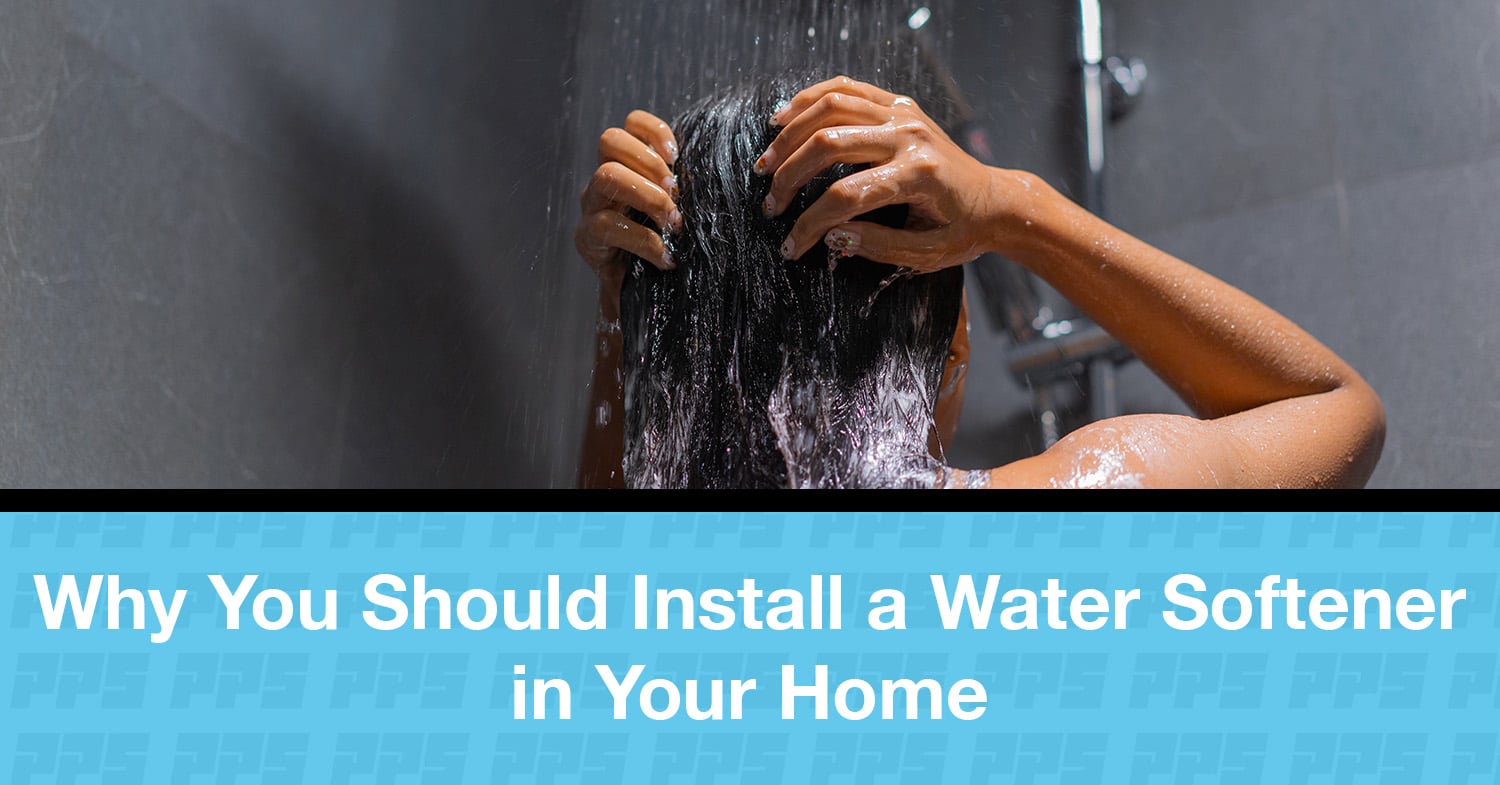 A woman washing her hair in a shower, reaping the benefits of a water softener.